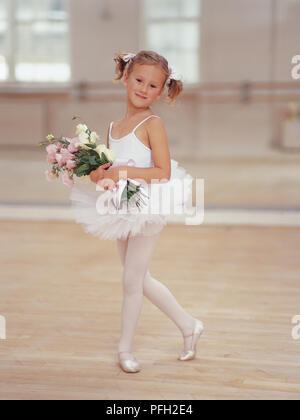 Junge Ballett Tänzerin in Knicks position Holding Blumenstrauß. Stockfoto