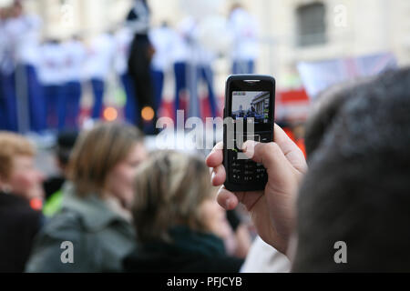 Grossbritannien, England, London, Frau unter Bild auf Ihrem Mobiltelefon bei Olympischen Parade, Oktober 2008 Stockfoto