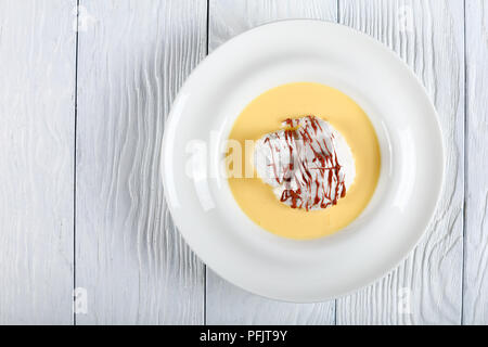 Elegante französische Dessert - eine schwimmende Insel ist ein Dessert französischer Herkunft, bestehend aus Baiser schwimmend auf Creme Anglaise oder Vanillepudding Stockfoto