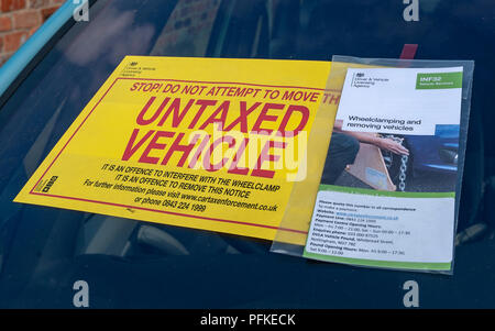 Eine unversteuerte Fahrzeug Bekanntmachung klemmt auf der Frontscheibe eines unversteuerten Auto Stockfoto