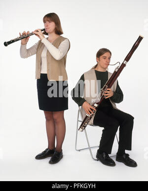 Jugendmädchen spielen Oboe, neben sitzt, Teenager spielen Fagott, Vorderansicht Stockfoto