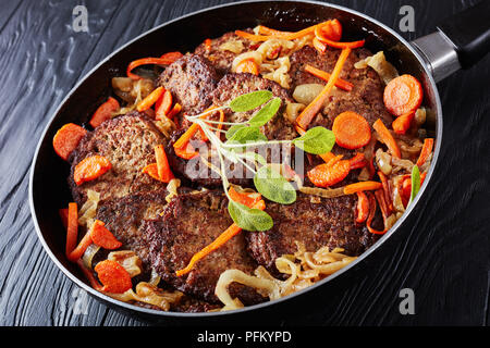 Lecker Huhn Leber Pfannkuchen geschmort mit Karotte und Zwiebel in einer Pfanne, gesundes Rezept, Ansicht von oben, close-up Stockfoto