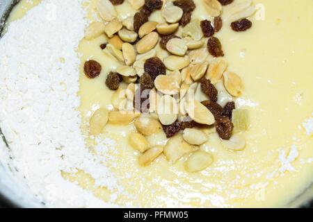 Auf einem weißen Hintergrund isoliert liegt eine Mischung aus Nüssen und Früchten. Die Mischung besteht aus Erdnüssen, kandierte Früchte, Rosinen und getrocknete Bananen. Ingredie Stockfoto