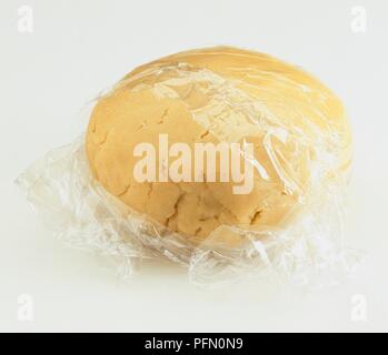 Ball Der mürbteig Teig in Frischhaltefolie eingewickelt, close-up Stockfoto