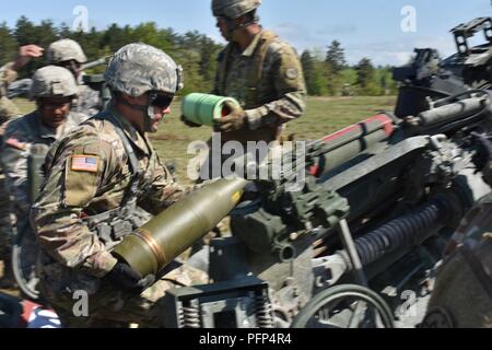 New York National Guard Pfc. Justin Tischler, Charlie Batterie zugewiesen, 1st Battalion, 258Th Field Artillery, lädt eine Runde in eine M777 Haubitze, auf Fort Drum, Watertown NY, Mai 22., 2018. Carpenter war Teil des Vierten gun Crew, das M 777 für Ihre erste Live-Feuer verwenden. (N.Y. Army National Guard Stockfoto