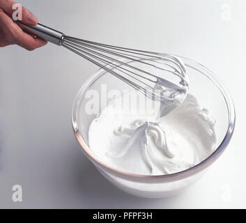 Baiser Mischung auf Schneebesen in Glas Schüssel, close-up Stockfoto