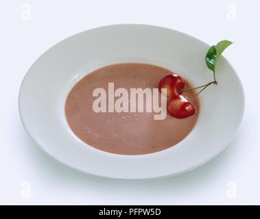 Ungarische cherry Suppe in weiße Schüssel garniert mit frischen Kirschen serviert. Stockfoto