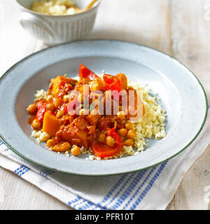 Gemüse Tajine (TAJINE), Kürbis, Paprika, Kichererbsen, serviert mit Couscous, auf einer Platte Stockfoto