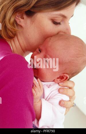 Frau mit einem neugeborenen Baby Mädchen nahe an ihr Gesicht, Nahaufnahme Stockfoto