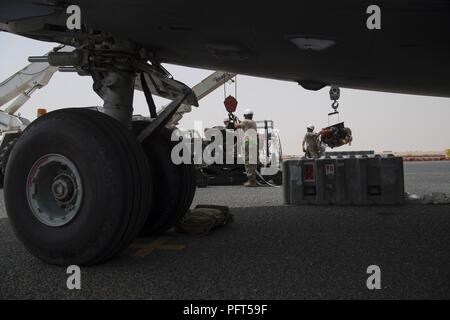 Betreuer aus dem 5 Expeditionary Air Mobility Squadron Austauschen einer Auxiliary Power Unit auf einer C-17 Globemaster III von Charleston, S.C. an einem geheimen Ort im Südwesten Asien, 31. Mai 2018. Zwei Kräne wurden eingesetzt, um die schwere Ausrüstung zu bewegen. Stockfoto