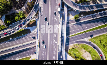 Autobahn und Überführung von Pkw und Lkw, Autobahnkreuz, zwei-Kreuzung in die große Stadt. Ansicht von oben. Stockfoto