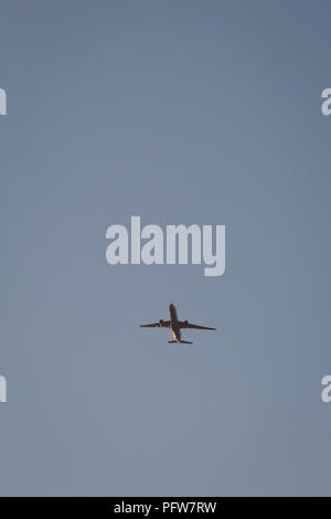 Eine generische Jet Airliner fliegen Overhead am blauen Himmel auf dem Flug-Pfad in London Heathrow Airport, am 10. August 2018 in London, England. Stockfoto