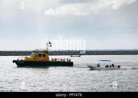 COATZACOALCOS, VER/MEXIKO - 18 Aug, 2018: eine maritime pilot Schiff, Avimar-1, am Wellenbrecher auf der Flussmündung. Ein wassertaxi und ein Fischerboot Stockfoto