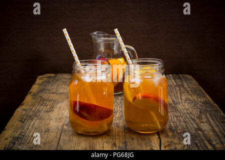 Zwei Gläser Pfirsich Orange Eistee auf Holz Stockfoto
