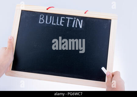 Hand holding the board  with the title of bulletin Stockfoto