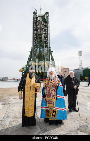 Ein orthodoxer Priester segnet die Mitglieder der Medien im Kosmodrom Baikonur Startrampe, Dienstag, 20. März 2018 in Baikonur, Kasachstan. Expedition 55 Sojus Commander Oleg Artemyev von Roskosmos, Ricky Arnold und Drew Feustel der NASA sind geplant, um die Internationale Raumstation an Bord der Sojus MS-08 Raumfahrzeugs auf Mittwoch, März, 21 zu starten. Stockfoto