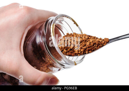 Weibliche Hand hält Glas Glas und Löffel mit Instant Kaffee auf weißem Hintergrund Stockfoto