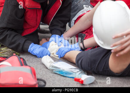 Erste Hilfe training mit der Simulation von Unfall am Arbeitsplatz und helfen verletzten Arbeitnehmer Stockfoto