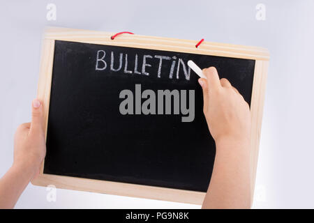Hand holding the board  with the title of bulletin Stockfoto