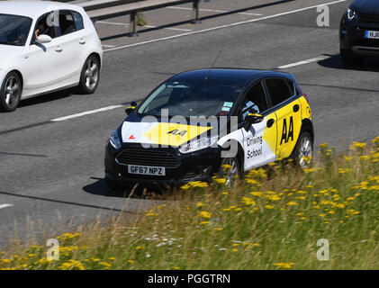 AA Fahrschule Auto Fahren auf eine zweispurige Straße. Stockfoto