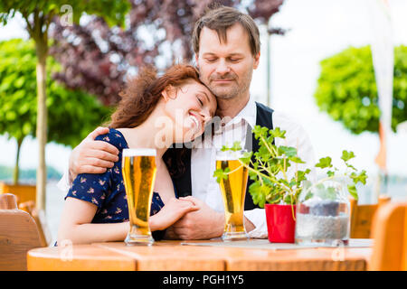 Paar in der Liebe kuscheln im Biergarten Stockfoto