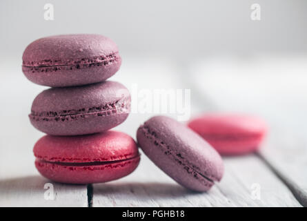 Gruppe der Macarons aus Erdbeeren, Sahne, Schokolade und Heidelbeeren. Rustikale Foto. Makro. Stockfoto