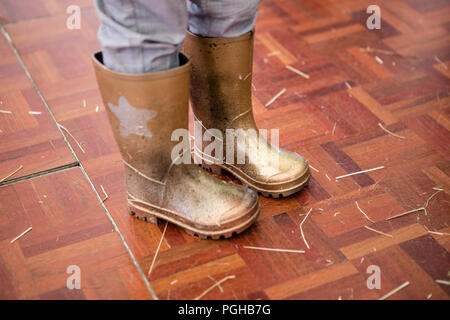 Nahaufnahme der lackiert Gold party wellies auf Kleinkind Stockfoto