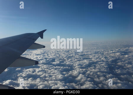Wolken durch das Fenster von Jet Flugzeug gesehen. Flugzeug fliegt bei über dreißig tausend Füße vom Boden. Stockfoto
