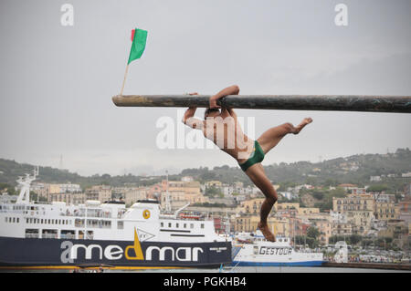 Pozzuoli, Italien. 26 Aug, 2018. Die pennone a Mare ist eine traditionelle Wettbewerb zwischen den Fischern von Pozzuoli auf dem Molo Caligoliano. Die Veranstaltung ist, dass die Fischer im Rennen muss drei Flaggen in die Enden der Stange mit Seife abgedeckt wurden die Fangmöglichkeiten und mit Blick auf das Meer. Das Rennen wurde verschoben am 15. August in ein Zeichen der Nähe zu der Stadt Genua nach dem Zusammenbruch der Morandi Brücke erfolgt heute 26. August 2018. Credit: Paola Visone/Pacific Press/Alamy leben Nachrichten Stockfoto