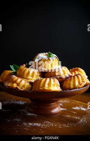 Süße Muffins Quark in Zucker Puder auf dem Holztisch Stockfoto