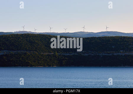 Windenergieanlagen auf einem Hügel über dem Meer. Platz kopieren Stockfoto