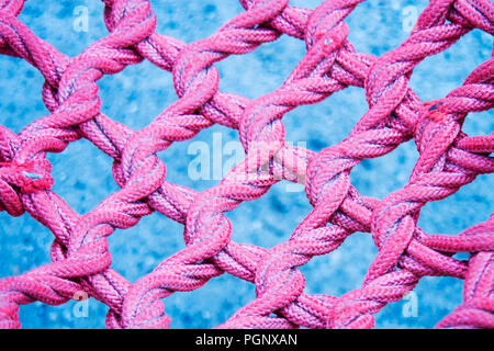 Rosa twisted, interlaced Seil, der faserstruktur Hintergrund. Stockfoto