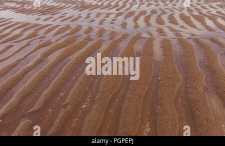 Wellen im sand Stockfoto