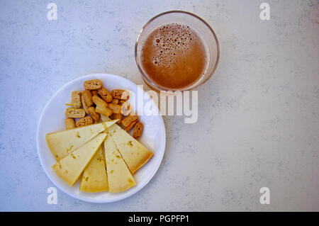 Ein Glas Bier, Käse und Crackern, Centre, Ansicht von oben Stockfoto