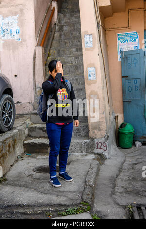 SIKKIM, INDIEN - Mar 13, 2017: Unbekannter indisches Mädchen mit backpck glättet Ihr Haar. Stockfoto