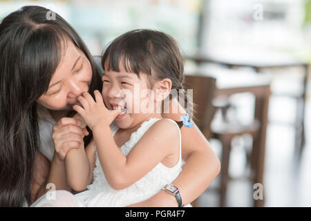 Candid Schießen von Menschen in der Cafeteria. Kleines Mädchen mit verschiedenen Gesichts Ausdruck. Asiatische Familie Lebensstil im Freien mit natürlichem Licht. Stockfoto