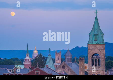 Die ikonischen Kirchtürmen Linie die Skyline, die zum Capitol Building von Charleston, West Virginia als der Vollmond am Abendhimmel hängt. Stockfoto