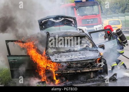 Gdynia, Polen. 27 Aug, 2018. Auto Feuer auf der S6 Autobahn (dreistadt Ringstraße) in Gdynia. Feuerwehrmänner aus der Staatlichen Polnischen Feuerwehr (Straz Pozarna) werden gesehen, während sie versuchen, das Feuer des Renault Auto zu kontrollieren. Auto begann zu brennen heftig während der Fahrt. Credit: Vadim Pacajev/Pacific Press/Alamy leben Nachrichten Stockfoto