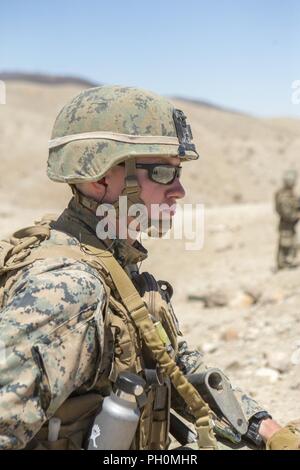 Cpl. Tristan Dugas, einem truppführer mit Firma A, 1st Bataillon, 23 Marine Regiment, 4 Marine Division, beobachtet sein Team Ihre M240 Maschinengewehr für eine Air Assault Kurs vorbereiten, bevor eine fiktive Feind, während integrierte Ausbildung Übung 4-18, an Bord der Marine Corps Air Ground Combat Center Twentynine Palms, Calif., 16. Juni 2018. ITX 4-18 bietet Marine Air-Ground Task Force Elemente eine Chance service durchzumachen - Ebene Kompetenzbewertungen, so dass Sie nahtlos mit Active Duty Marines im Falle von Krisen, erfordert eine schnelle Reaktion zu integrieren. Stockfoto