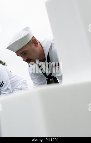 Normandie, Frankreich (19. Juni 2018) Hospital Corpsman 2. Klasse Chuck Claxton, führenden Petty Officer für die U.S. Naval Hospital Neapel Ehrengarde, probt vor der Trauerfeier für Radioman 2. Klasse Julius "Henry" Pieper Normandie an der Amerikanischen Friedhof. Henry Pieper und seinem Zwillingsbruder, Radioman 2. Klasse Ludwig "Louie" Pieper, waren beide getötet, als ihr Schiff, Landing Ship Tank (LST) 523, schlug eine vor der Küste von Frankreich am 19. Juni 1944. Louie's Überreste wurden sofort gefunden, aber Henry's Überreste wurden nicht bis Dezember 2017 identifiziert. Die Familie beantragt, dass Henry b Stockfoto