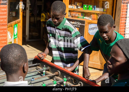 SAINT LOUIS, SENEGAL - Apr 24, 2017: Unbekannter senegalesischen Jungen das Board spielen Fußball in Saint Louis, eine der größten Städte in Senegal Stockfoto