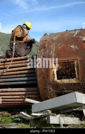 Greymouth, Neuseeland, 14. MAI 2018: Ein Ingenieur Schnitte, eine alte Kessel für Schrott Stockfoto