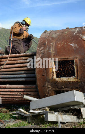 Greymouth, Neuseeland, 14. MAI 2018: Ein Ingenieur Schnitte, eine alte Kessel für Schrott Stockfoto