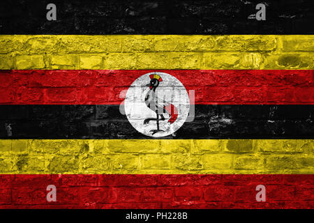 Flagge Uganda über eine alte Mauer Hintergrund, Oberfläche Stockfoto