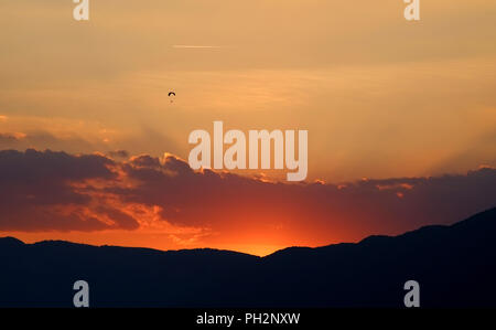 Gleitschirm Silhouette in den spanischen Pyrenäen, Katalonien, bei Sonnenuntergang. Stockfoto