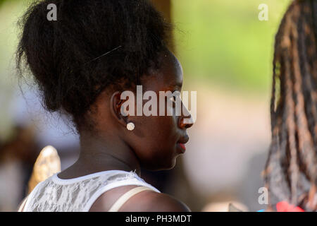 OUSSOUYE, SENEGAL - Apr 30, 2017: Unbekannter senegalesische Frau in weißem Hemd earing im heiligen Wald in der Nähe von Kaguit Dorf Stockfoto