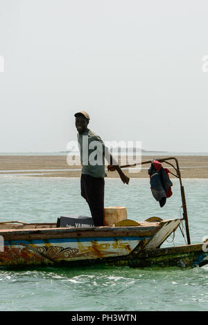 ORANGO INSEL, GUINEA BISSAU - Mai 3, 2017: Unbekannter lokaler Mann segelt in einem Boot auf der Insel Orango, Guinea Bissau Stockfoto