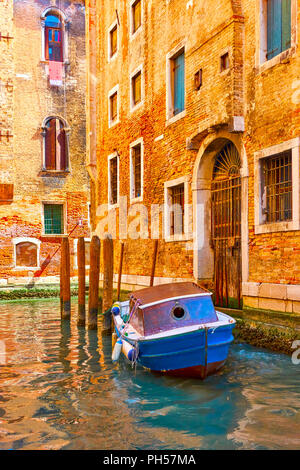 Gebäude, die durch den Kanal und günstig altes Boot in Venedig, Italien Stockfoto