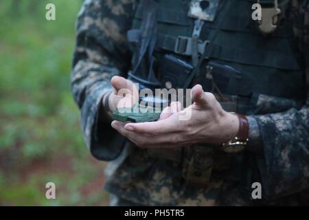 Spc. Christian Caudle, ein infanterist an die Zentrale und die Konzernzentrale, 2nd Battalion, 505Th Parachute Infantry Regiment zugeordnet, 3. Brigade Combat Team, 82nd Airborne Division schießt seine Azimut während der Navigation Teil des XVIII Airborne Corps Soldat des Jahres Wettbewerb, 26. Juni 2018 in Fort Bragg, North Carolina. Caudle kam zuerst während der Navigation Wettbewerb und fanden alle fünf Punkte. Stockfoto