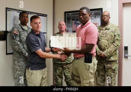 Spc. Laziano George, Virgin Islands National Guard seiner 661 Militär Polizei Recht und Ordnung Loslösung, erhält sein Zertifikat von Staff Sgt. Patrick Sanders, Ft. Polk 91st militärischen Polizeiaufgebot, für den Abschluss einer mechanischen Steuerung hält (MACH) und Oleoresin capsicum (OC) Spritz- und X26-Serie taser Kurs als Teil des jährlichen Trainings an ft. Polk, LA, 26. Juni 2018. Dieses Training erneut und setzen die Mitglieder der seiner 661 Militär Polizei Recht und Ordnung Loslösung militärischer berufliche Spezialität zu verwenden. Stockfoto